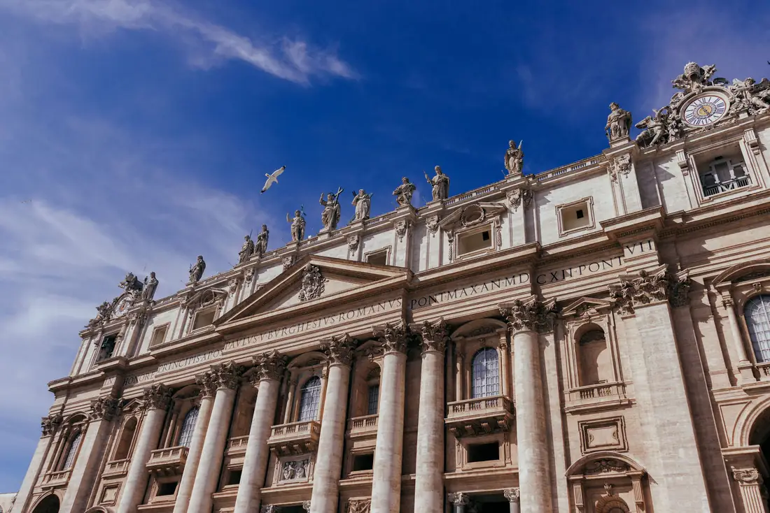 The facade of St. Peter's Basilica against a blue sky.